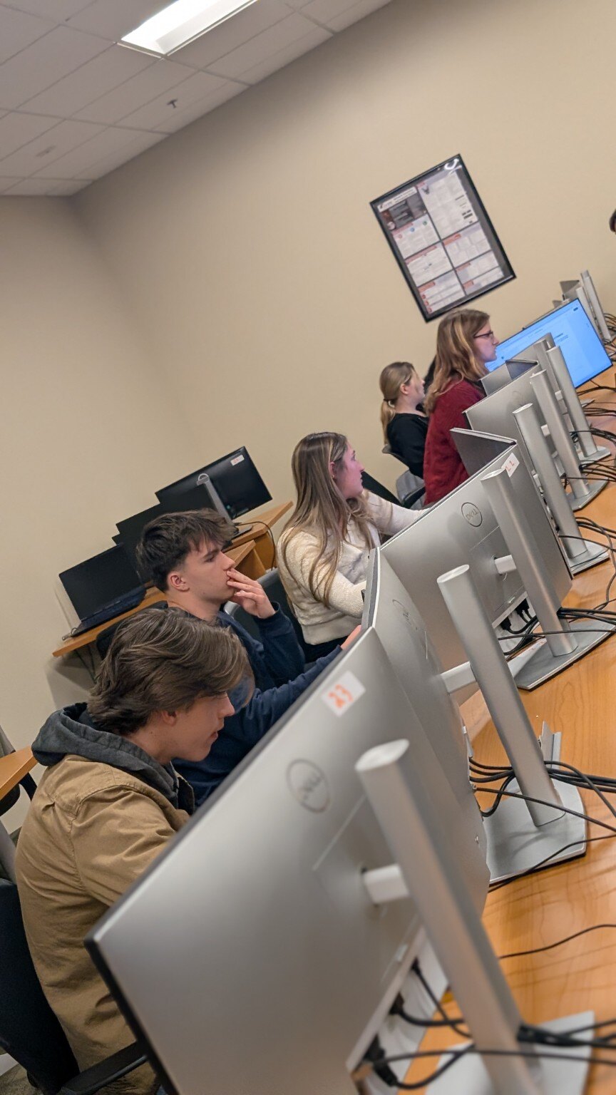 Students working through a WVBF cybersecurity exercise in a university computer lab
