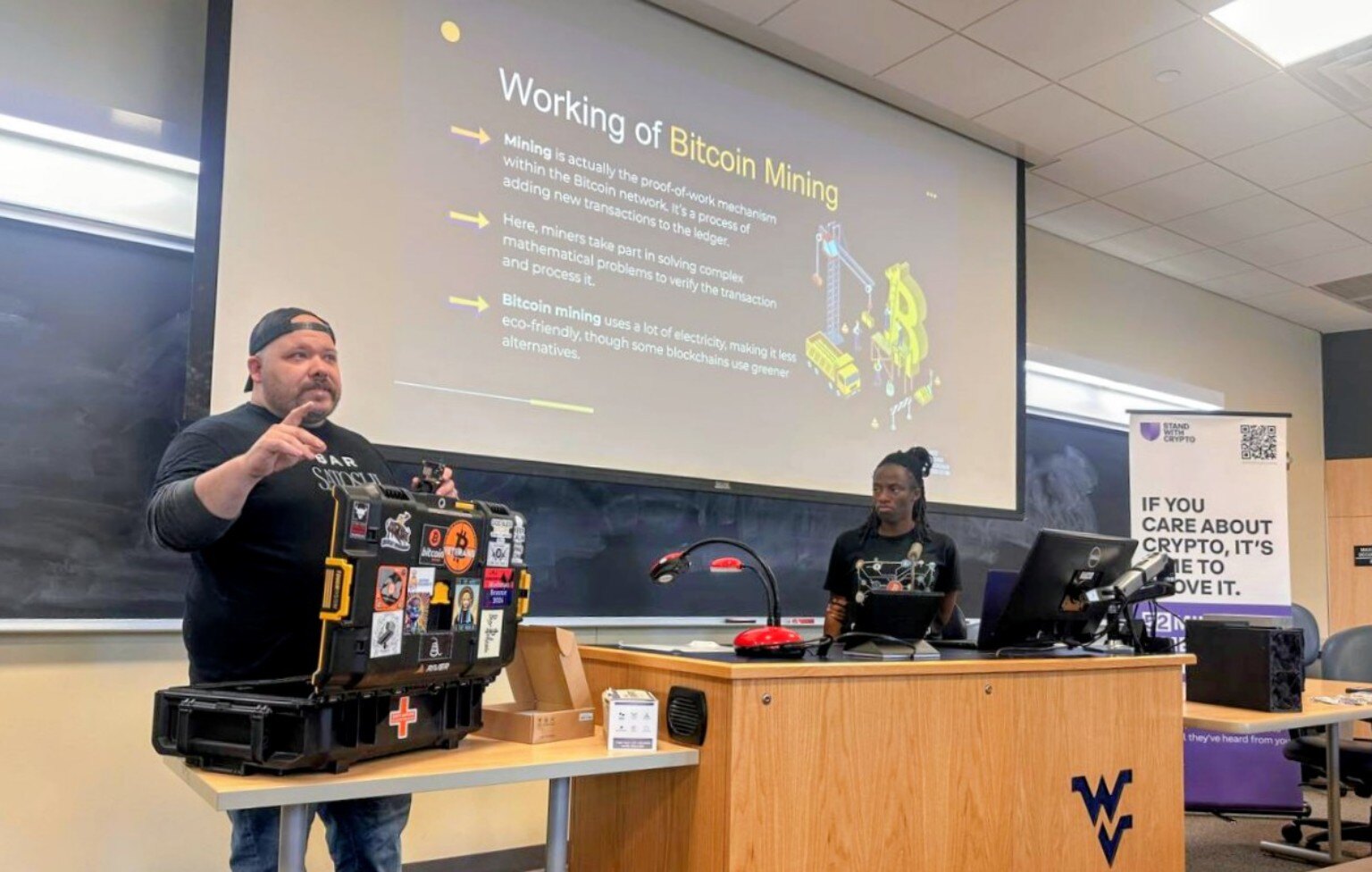 A guest educator discussing Bitcoin mining during a WVBF university workshop